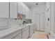 Bright laundry room with ample counter space and built-in cabinets at 3372 Bellington Dr, Orlando, FL 32835