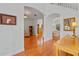 Open-concept living room with hardwood floors, archways, and neutral paint at 3372 Bellington Dr, Orlando, FL 32835