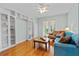 Cozy living room with hardwood floors, built-in shelves, and backyard access at 3372 Bellington Dr, Orlando, FL 32835