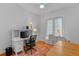 Bright office space featuring a built-in desk and storage, wood floors, and bright light at 3372 Bellington Dr, Orlando, FL 32835