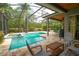 This screened pool area features a built-in hot tub, stone tile and lots of space for outdoor entertaining at 3372 Bellington Dr, Orlando, FL 32835