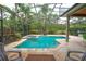 This screened in-ground pool area is complete with a hot tub and a seating area for easy relaxation and outdoor living at 3372 Bellington Dr, Orlando, FL 32835