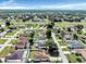 An aerial view captures a quiet neighborhood with a mix of homes and green spaces at 340 Edgewood Ct, Kissimmee, FL 34759