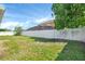 Large backyard featuring a white fence and green grass at 340 Edgewood Ct, Kissimmee, FL 34759
