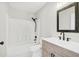 Updated bathroom featuring a wood-look vanity, black fixtures, and a shower and tub combo at 340 Edgewood Ct, Kissimmee, FL 34759