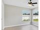 Bright bedroom features neutral walls, wood-look floors, and two windows offering plenty of light at 340 Edgewood Ct, Kissimmee, FL 34759