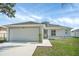 Charming one-story home featuring a two-car garage, sidewalk and a well-maintained lawn at 340 Edgewood Ct, Kissimmee, FL 34759
