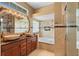 An elegant bathroom showcasing double sinks, a large tub, and a glass-enclosed shower at 3593 Scoutoak Loop, Oviedo, FL 32765