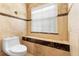 Powder room featuring marbled tile and natural light from window at 3593 Scoutoak Loop, Oviedo, FL 32765