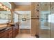 An elegant bathroom showcasing double sinks, a large tub, and a glass-enclosed shower at 3593 Scoutoak Loop, Oviedo, FL 32765