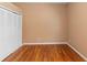 Empty bedroom showcasing light-colored walls, wood floors and a closet with bi-fold doors at 3593 Scoutoak Loop, Oviedo, FL 32765