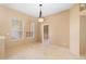 Bright dining room with tile flooring, a modern light fixture, and natural light from two windows at 3593 Scoutoak Loop, Oviedo, FL 32765