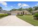 Traditional home with a lush lawn, driveway, attached garage, and manicured landscaping at 3593 Scoutoak Loop, Oviedo, FL 32765