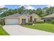 Inviting one-story home with a manicured front lawn, attached garage, and classic curb appeal at 3593 Scoutoak Loop, Oviedo, FL 32765