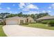 Charming one-story home with a manicured front lawn and a concrete driveway leading to an attached garage at 3593 Scoutoak Loop, Oviedo, FL 32765