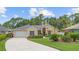 Charming one-story home with a well-manicured lawn, lush landscaping, and a cozy entrance at 3593 Scoutoak Loop, Oviedo, FL 32765