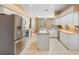 Bright kitchen featuring stainless steel appliances, tile floors, an island, and granite countertops at 3593 Scoutoak Loop, Oviedo, FL 32765