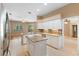 Open-concept kitchen featuring granite counters, white cabinets, a tile backsplash, and an island at 3593 Scoutoak Loop, Oviedo, FL 32765