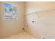 Simple laundry room with window, tiled floors, and a wire rack for drying clothes at 3593 Scoutoak Loop, Oviedo, FL 32765
