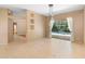 Spacious living room featuring neutral tones, tile flooring, access to other rooms, and a backyard view at 3593 Scoutoak Loop, Oviedo, FL 32765