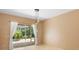 Bright room featuring a sliding glass door with white curtains leading to a screened pool area at 3593 Scoutoak Loop, Oviedo, FL 32765