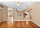 Hardwood floors in spacious living room leading to open kitchen with tile floors and a breakfast bar at 3593 Scoutoak Loop, Oviedo, FL 32765