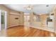 Spacious open-concept living room with hardwood flooring adjacent to a kitchen with tile flooring at 3593 Scoutoak Loop, Oviedo, FL 32765