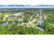 Neighborhood aerial view with a community lake surrounded by mature trees at 3593 Scoutoak Loop, Oviedo, FL 32765