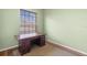 Study area with a large wooden desk and natural lighting from a nearby window at 3593 Scoutoak Loop, Oviedo, FL 32765