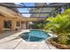 A gorgeous screened-in pool with paver decking and lush landscaping at 3593 Scoutoak Loop, Oviedo, FL 32765