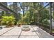 A beautiful screened in pool area with an outdoor fire pit and luscious landscaping at 3593 Scoutoak Loop, Oviedo, FL 32765