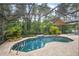 Sparkling pool with screened enclosure, brick paver deck and lush landscaping at 3593 Scoutoak Loop, Oviedo, FL 32765