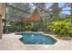 Screened-in pool featuring lush landscaping and a sun shade at 3593 Scoutoak Loop, Oviedo, FL 32765
