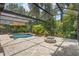A screened-in pool area with ample seating, paver decking, and lush landscaping at 3593 Scoutoak Loop, Oviedo, FL 32765