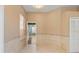Bright, neutral room featuring tile flooring, baseboard trim, and a view to another room at 3593 Scoutoak Loop, Oviedo, FL 32765