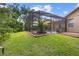 The screened patio features a plant bed and mature landscaping at 3593 Scoutoak Loop, Oviedo, FL 32765