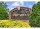 A decorative brick sign with 'Heronwood' text set amongst landscaped greenery at 3593 Scoutoak Loop, Oviedo, FL 32765