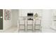 Eat-in kitchen featuring an island with bar stool seating and white cabinets at 4053 Old Mill Rd, Haines City, FL 33844