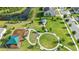 Aerial view of the community park area with blue gazebo, playground and walking paths at 417 Tisone Ln, Davenport, FL 33837
