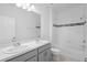 Bright bathroom boasts a tub and shower combination, with a double sink vanity at 417 Tisone Ln, Davenport, FL 33837