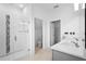 Bright bathroom features double sinks, neutral tiling, and a glass enclosed shower at 417 Tisone Ln, Davenport, FL 33837