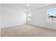 Empty bedroom featuring neutral carpet flooring and two bright windows at 417 Tisone Ln, Davenport, FL 33837
