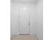 Simple white front door with modern hardware and tile flooring at 417 Tisone Ln, Davenport, FL 33837