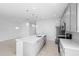 Spacious kitchen featuring an island with quartz countertops and modern pendant lighting at 417 Tisone Ln, Davenport, FL 33837