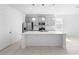 Contemporary kitchen featuring stainless steel appliances, gray cabinets, and a spacious island at 417 Tisone Ln, Davenport, FL 33837