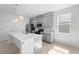 Modern kitchen featuring stainless steel appliances, quartz countertops, and abundant natural light at 417 Tisone Ln, Davenport, FL 33837