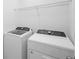 Laundry machines with neutral walls and wire shelving at 417 Tisone Ln, Davenport, FL 33837