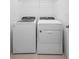 Laundry machines with neutral walls and tile floors at 417 Tisone Ln, Davenport, FL 33837