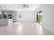 Bright open living area with tile floors, leading to a modern kitchen and outdoor view at 417 Tisone Ln, Davenport, FL 33837