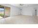 Bright living room featuring tile floors, ceiling fan, and sliding glass door access at 417 Tisone Ln, Davenport, FL 33837